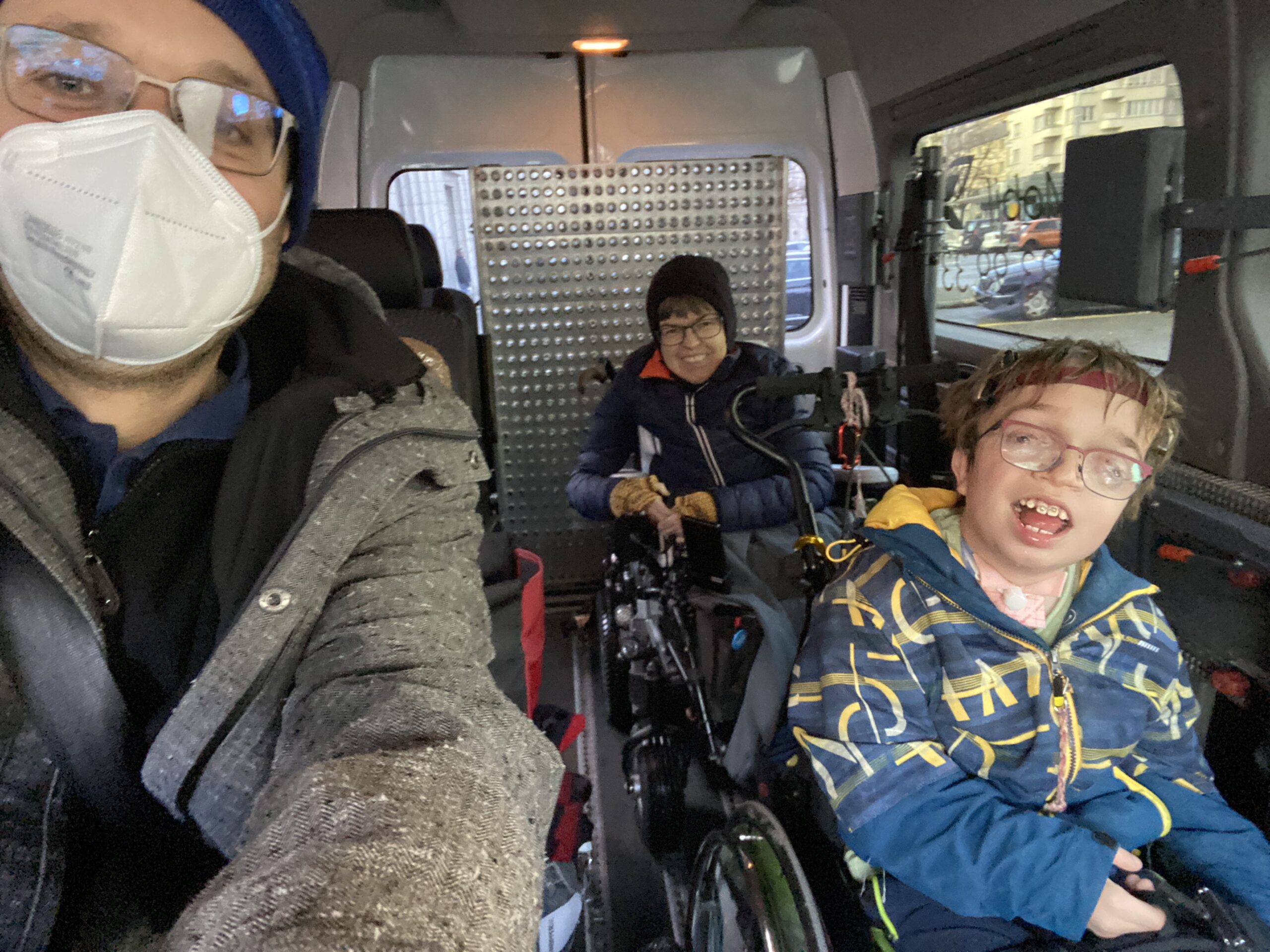 Selfie von drei Personen im Behindertentaxi